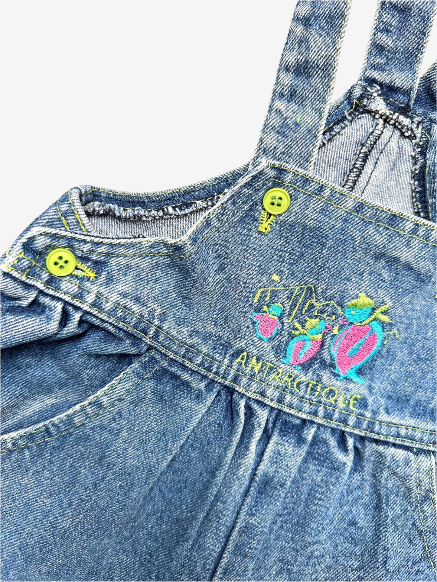 Kids vintage denim dungarees with a fun fluorescent penguin embroidery on the chest and bright pops of colour carried through the buttons and stitching. In a classic mid-blue wash with a relaxed bubble fit, they have gentle gathering at the waist for extra comfort. Age 18 months.