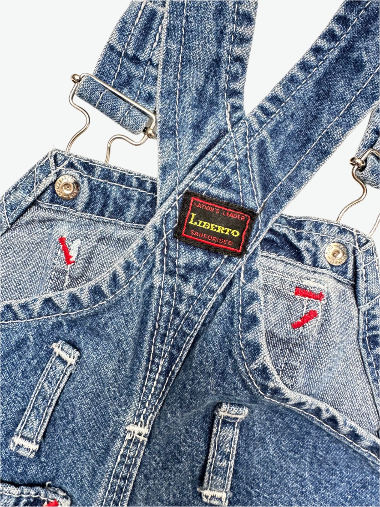 kids vintage denim dungarees by brand Liberto, true blue denim shade, faded in all the right places. Highlgith red bartacks. Age 1 yrs.