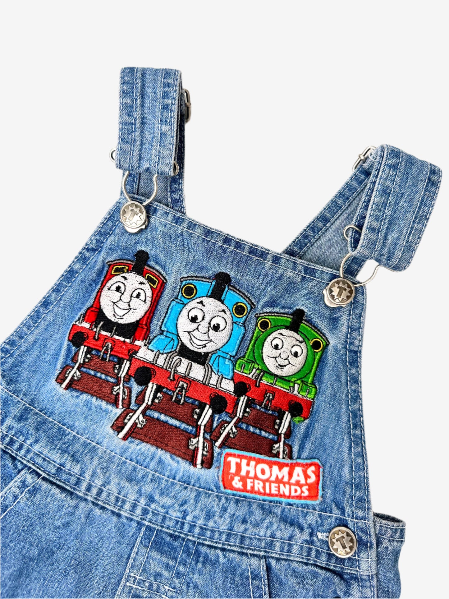 Kids Vintage Thomas the Tank Engine Short Dungarees in denim with detailed thomas and friends embroidery on the chest and branded T buttons. Age 2 yrs.