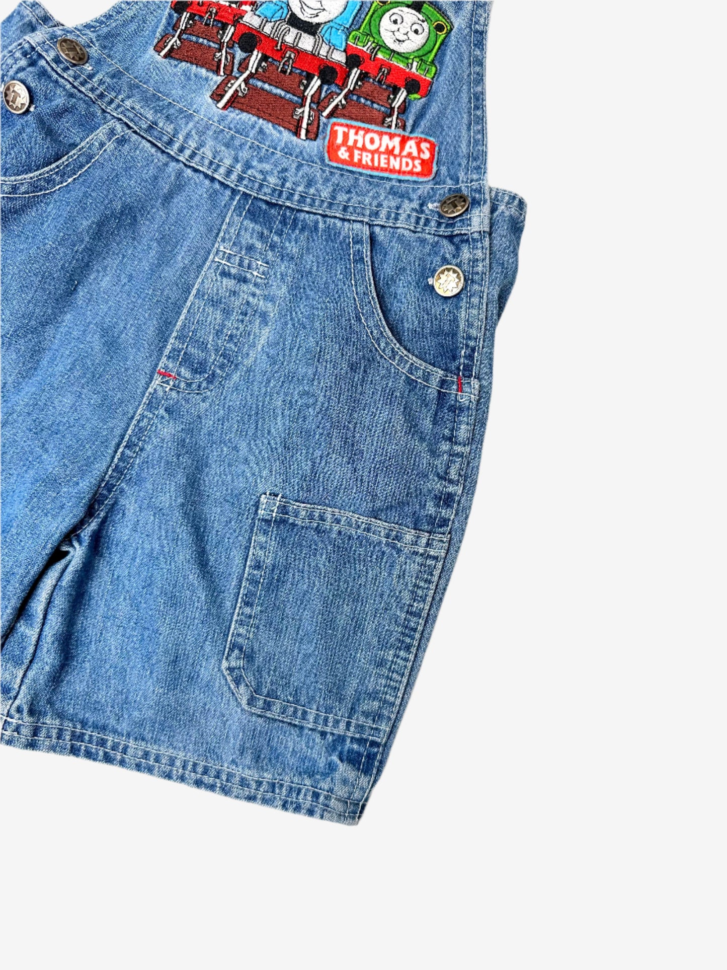 Kids Vintage Thomas the Tank Engine Short Dungarees in denim with detailed thomas and friends embroidery on the chest and branded T buttons. Age 2 yrs