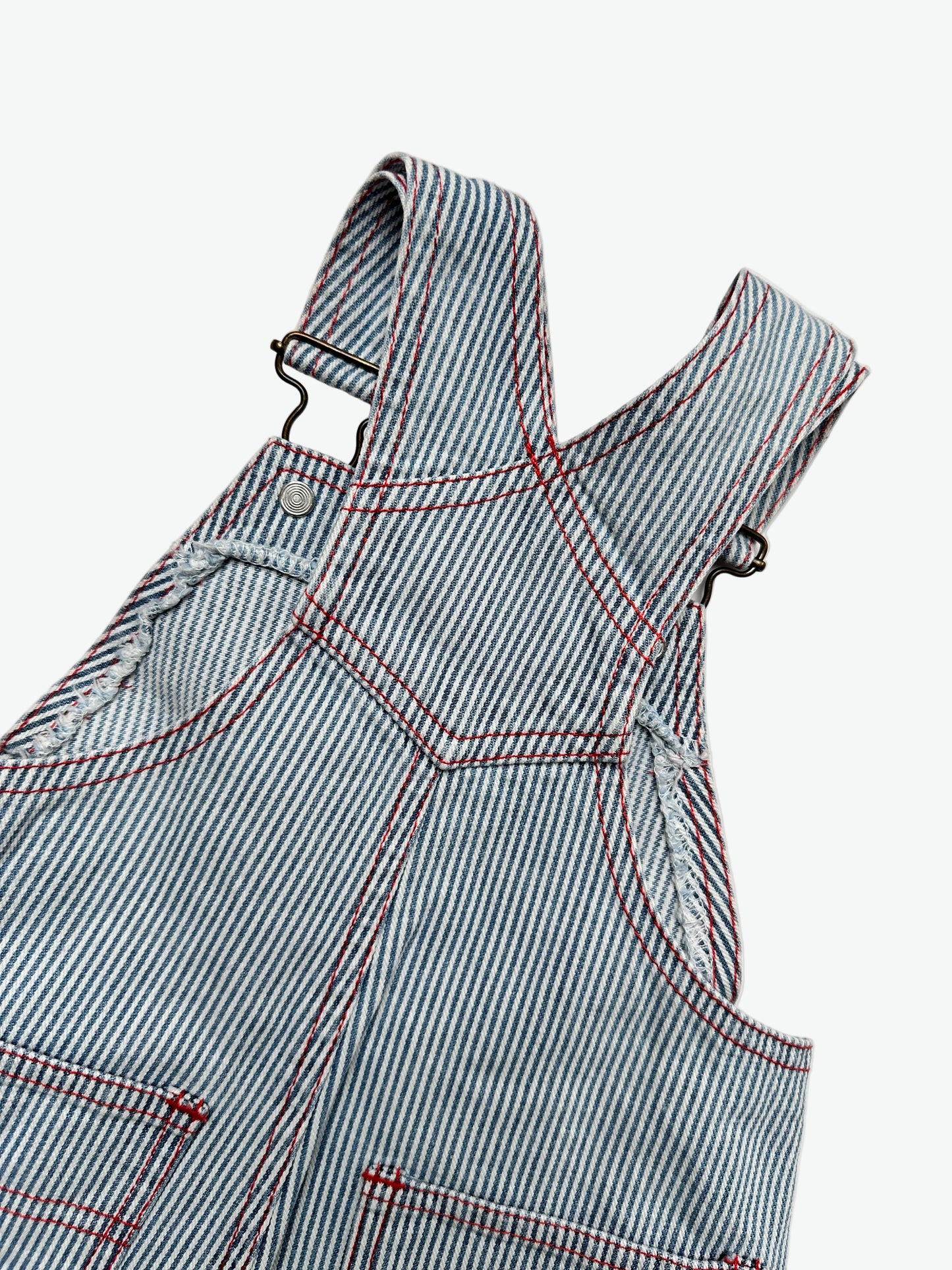 Kids vintage striped dungarees with contrast red stitching and a dog with the words'les petits calins'