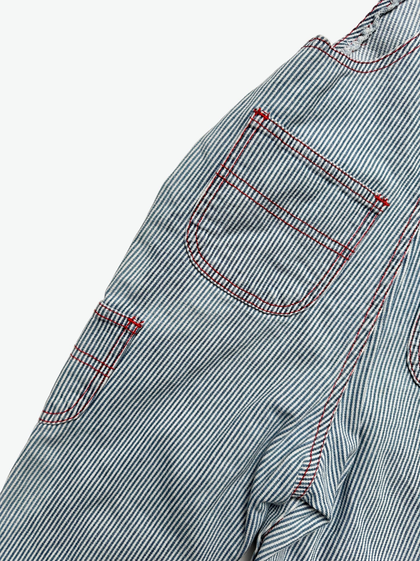 Kids vintage striped dungarees with contrast red stitching and a dog with the words'les petits calins'
