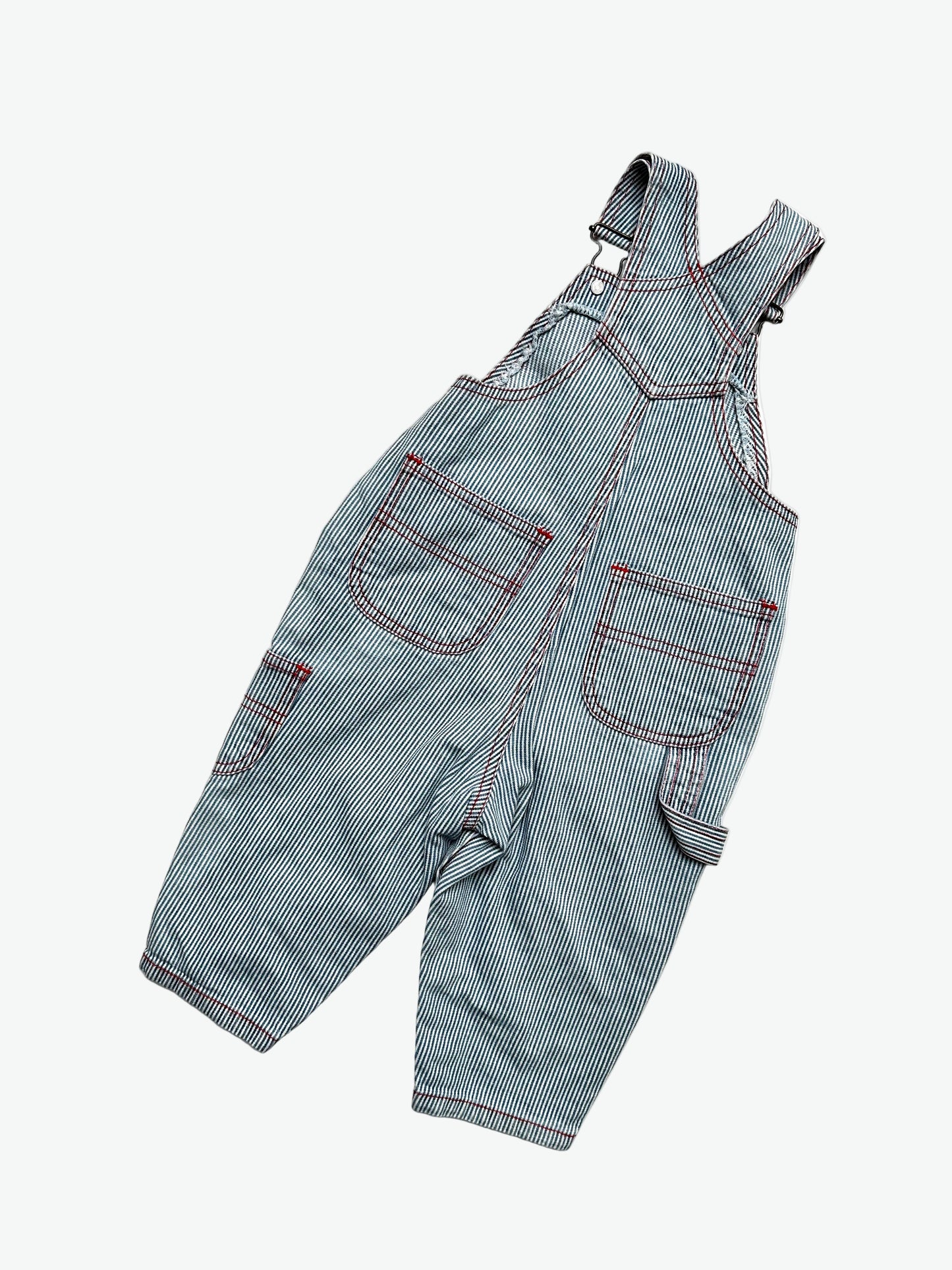 Kids vintage striped dungarees with contrast red stitching and a dog with the words'les petits calins'