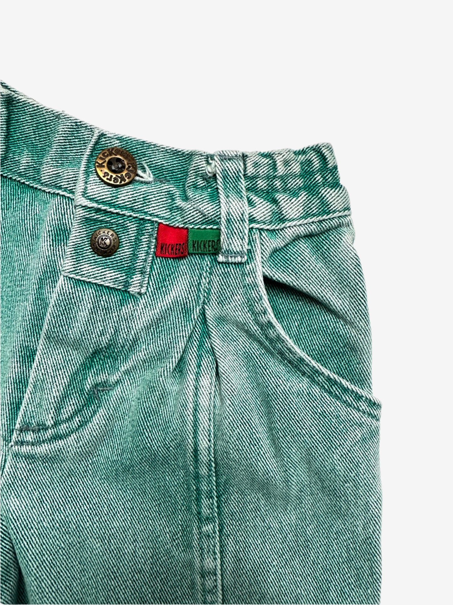 Kids vintage green denim jeans by Kickers, featuring an elasticated waist and button opening for an easy fit, the front darts and extra seams highlight the stunning wash effects, finished with the signature red and green Kickers tabs. Age 2 years.