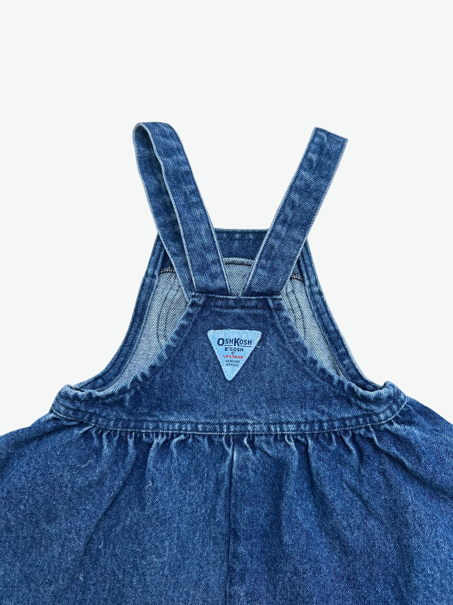 Kids vintage OshKosh dress in a thick and authentic denim fabric with antique brass trims and Oshkosh branding. Very full circle skirt.