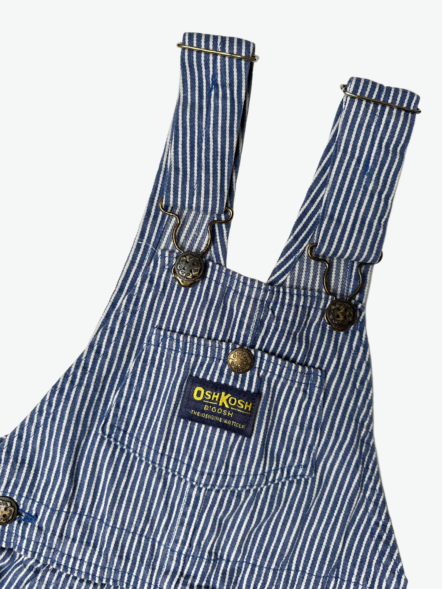 Kids vintage OshKosh dungarees in a blue and white hickory stripe with antique brass trims. Age 4 years.