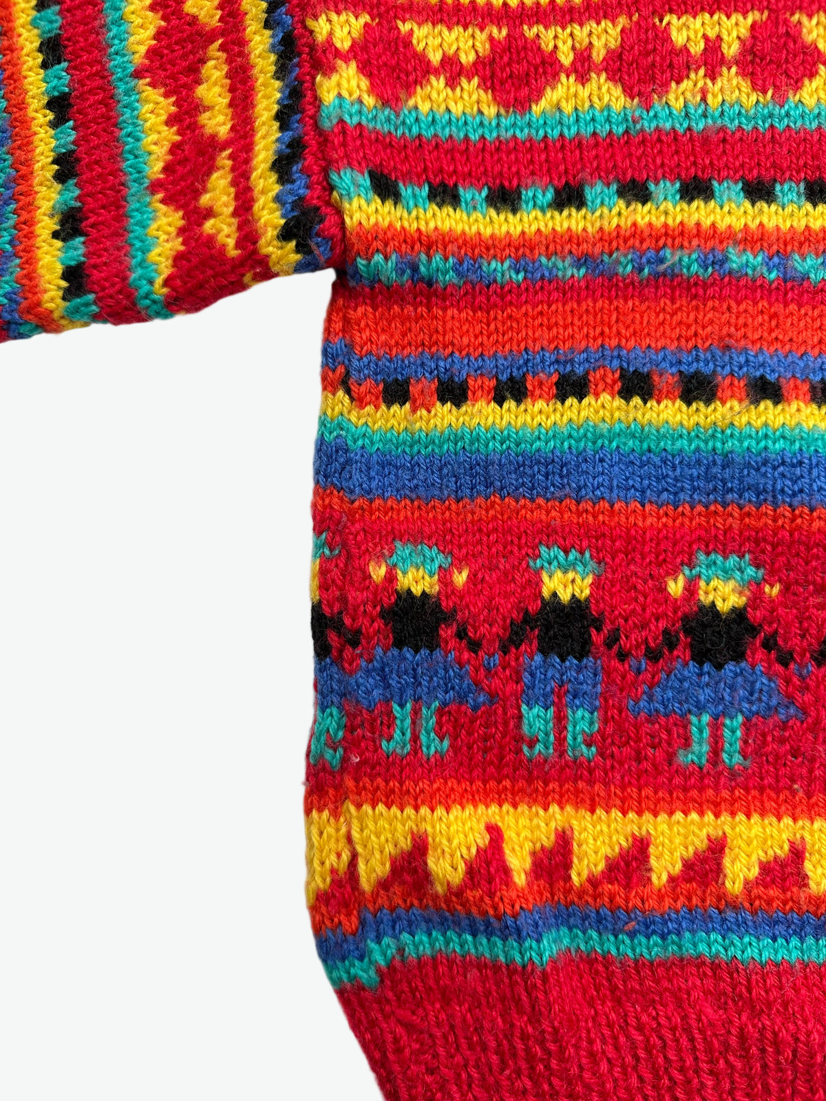 Kids vintage colourful hand knitted jumper with geometric pattern and little figures on a white background