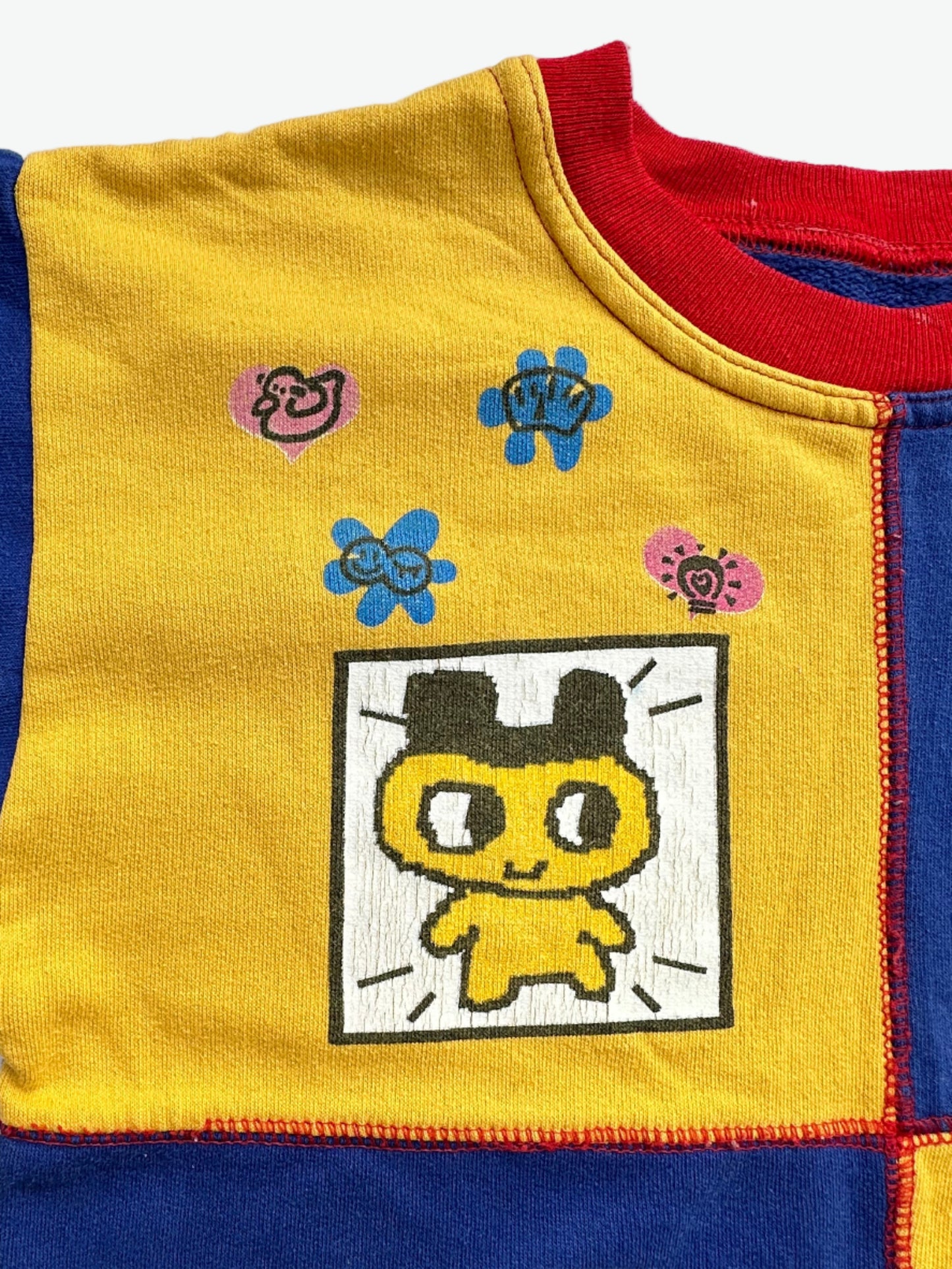 Kids vintage jumper branded Tamagotchi. Multi colour - red, blue and yellow, printed detail from 1996-1997. Age 10 years.