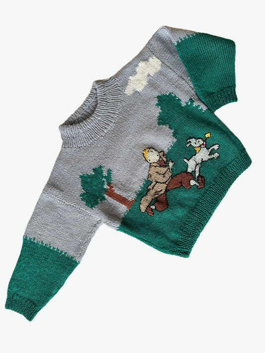 Kids hand knitted jumper with cartoon design of tin tin on a white background