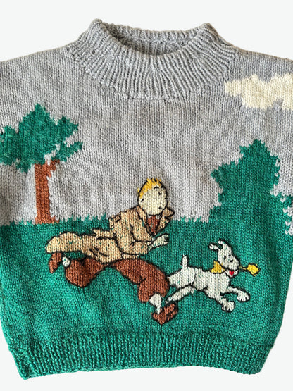 Knitted sweater with cartoon characters from tin tin on a plain background