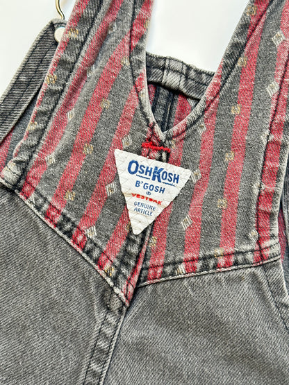 Kids vintage Grey and red denim dungarees with striped straps and Oshkosh brand label on a white background