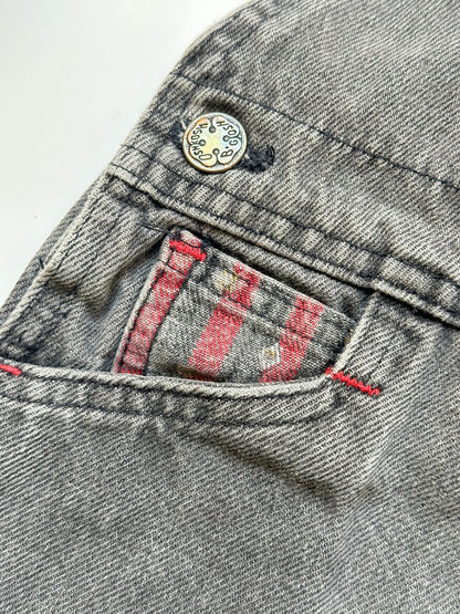 Kids vintage Grey and red denim dungarees with striped straps and Oshkosh brand label on a white background