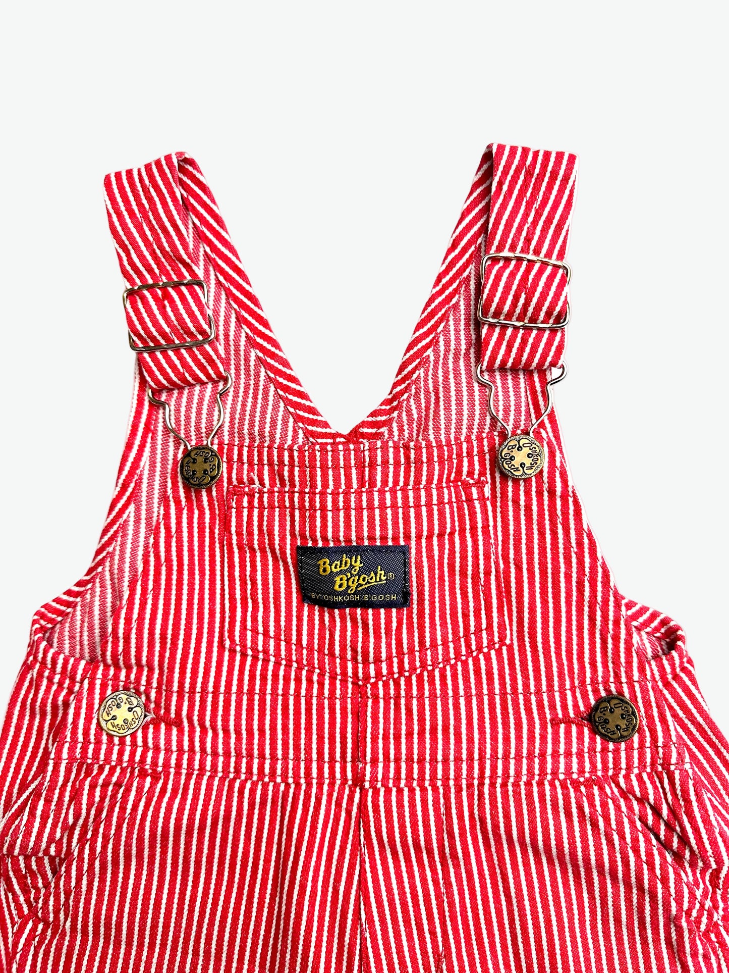 Red and white striped overalls with a visible oshkosh brand label on a white background
