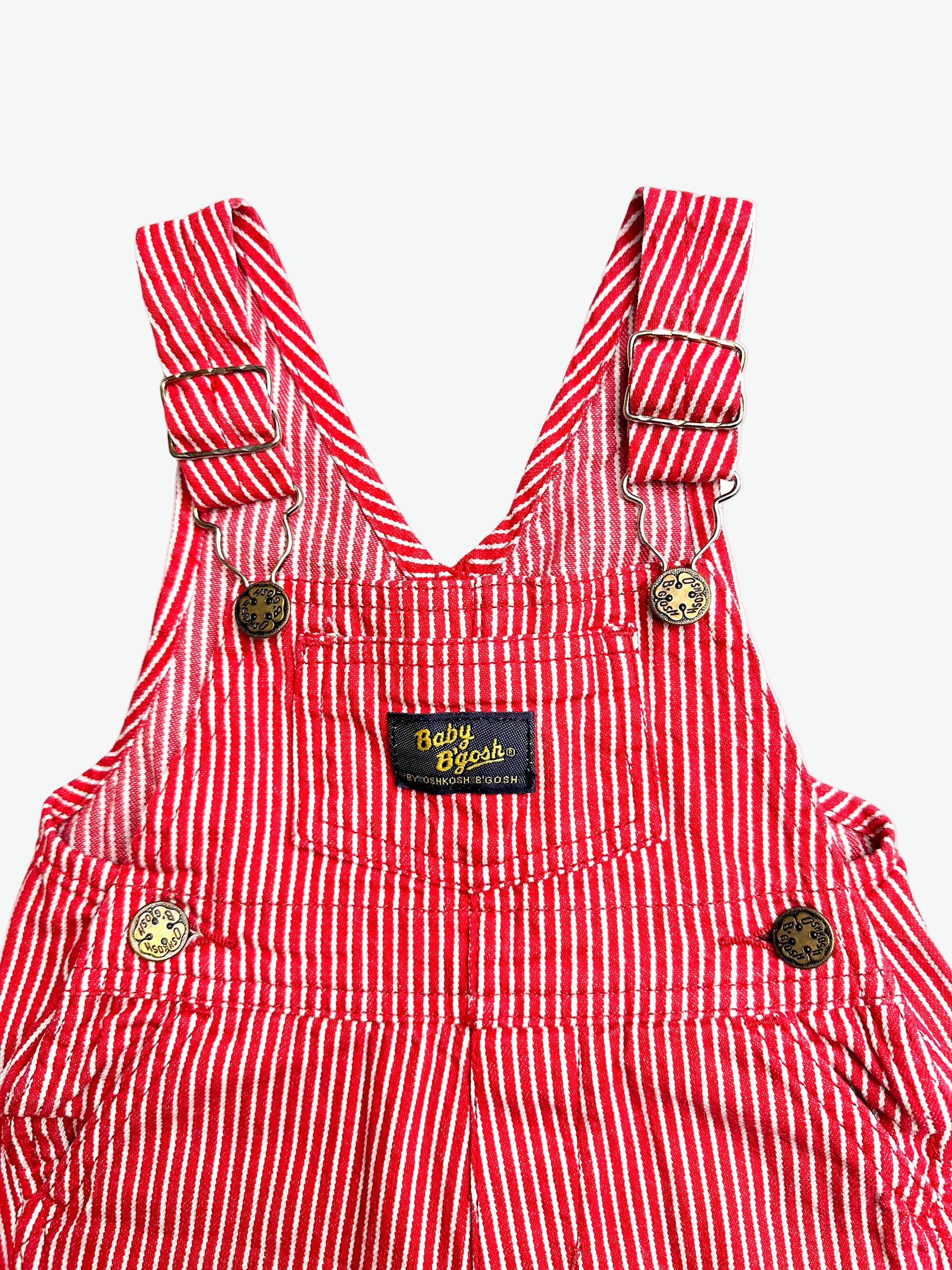 Red and white striped overalls with a visible oshkosh brand label on a white background