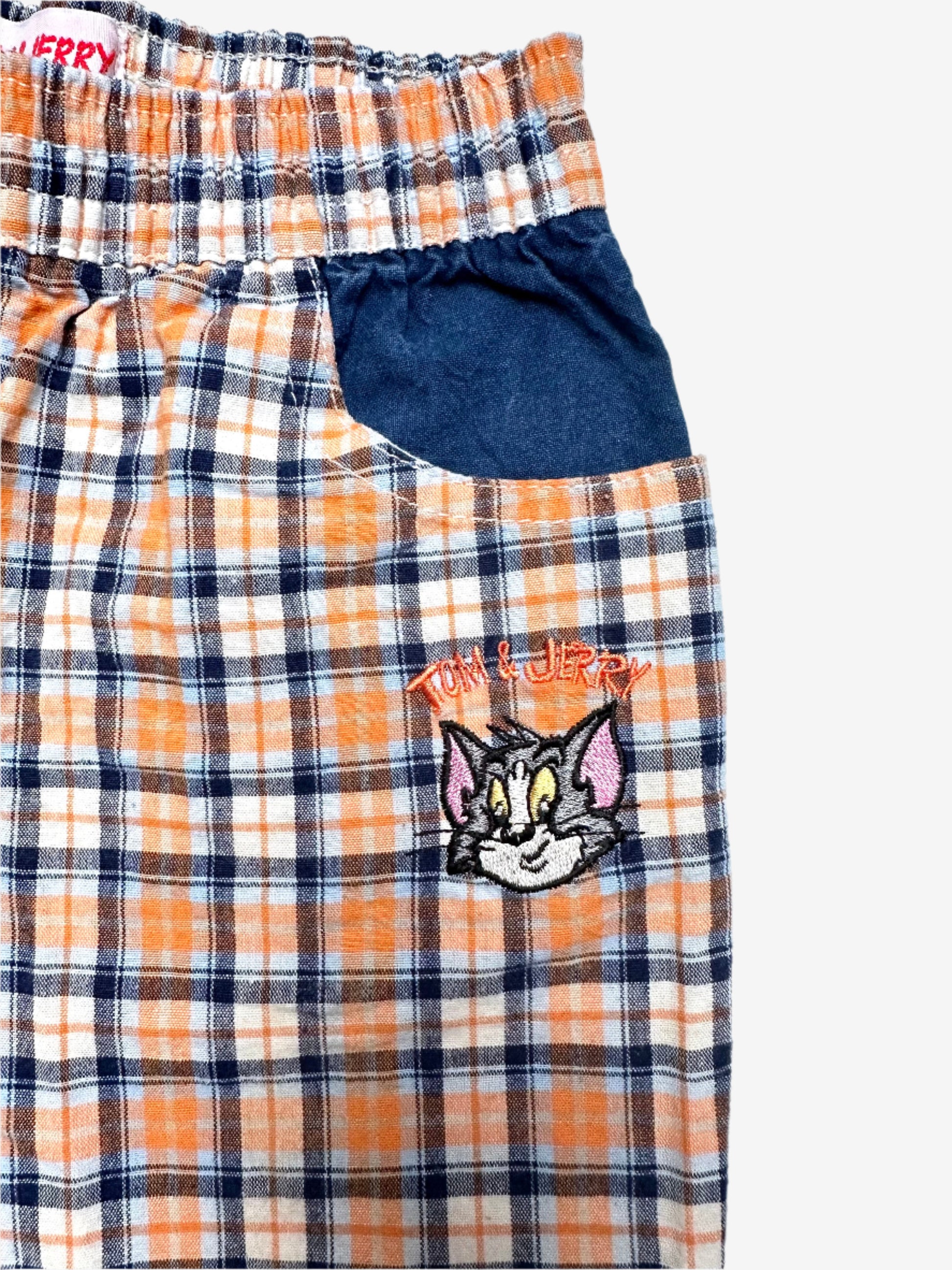Kids Vintage 90's Check Trousers with Tom & Jerry embroidered detail. Easy elastic waistband in relaxed fit. Lightweight fabric. 