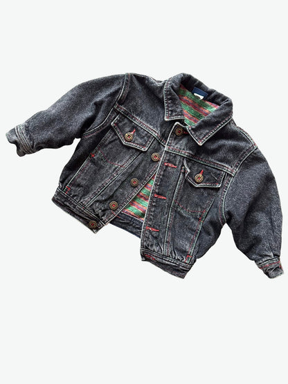 Kids vintage  faded black Denim jacket with red stitching, brass buttons and warm checkered lining on a white background