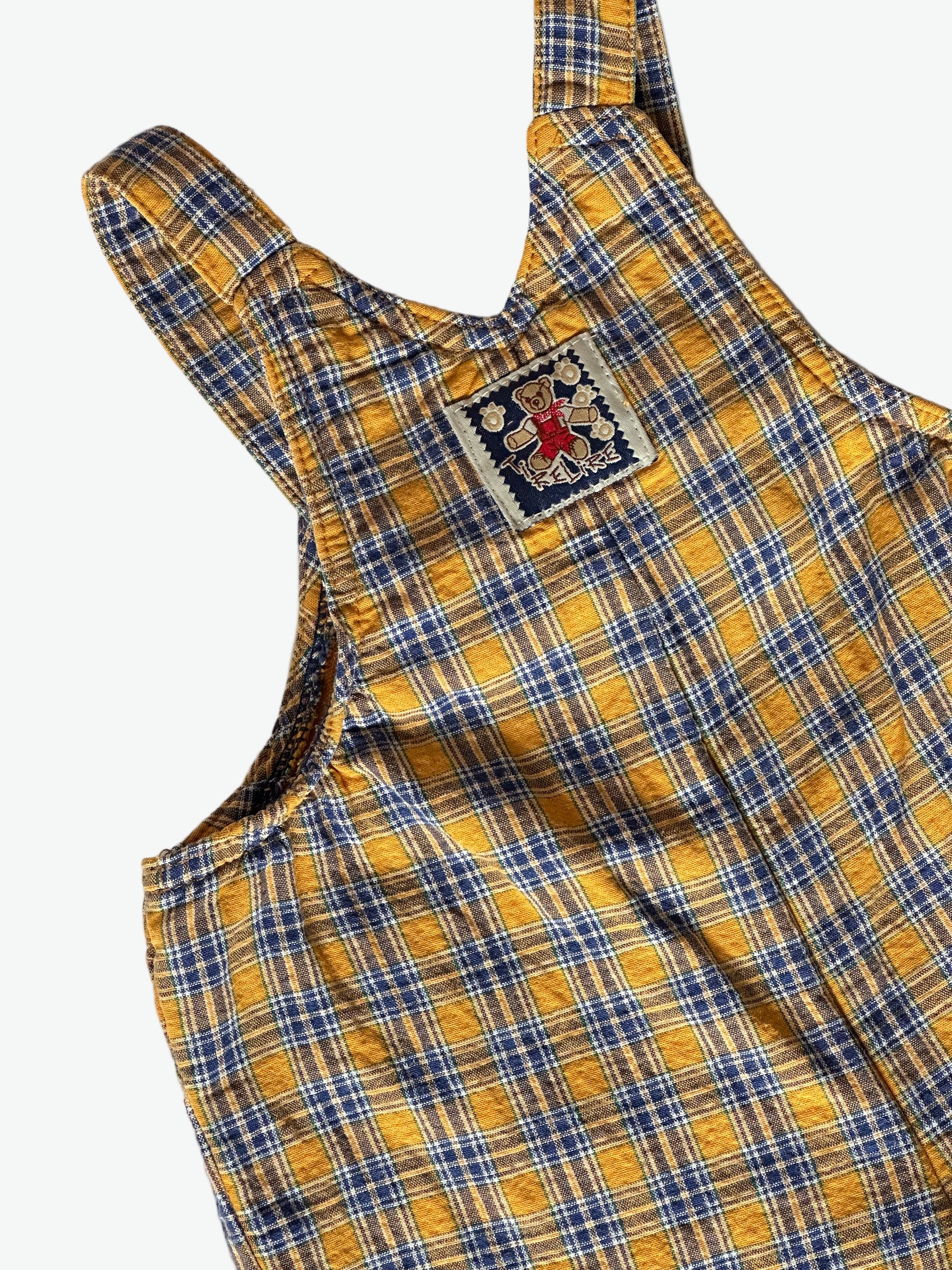 Yellow and blue check dungarees on a white background