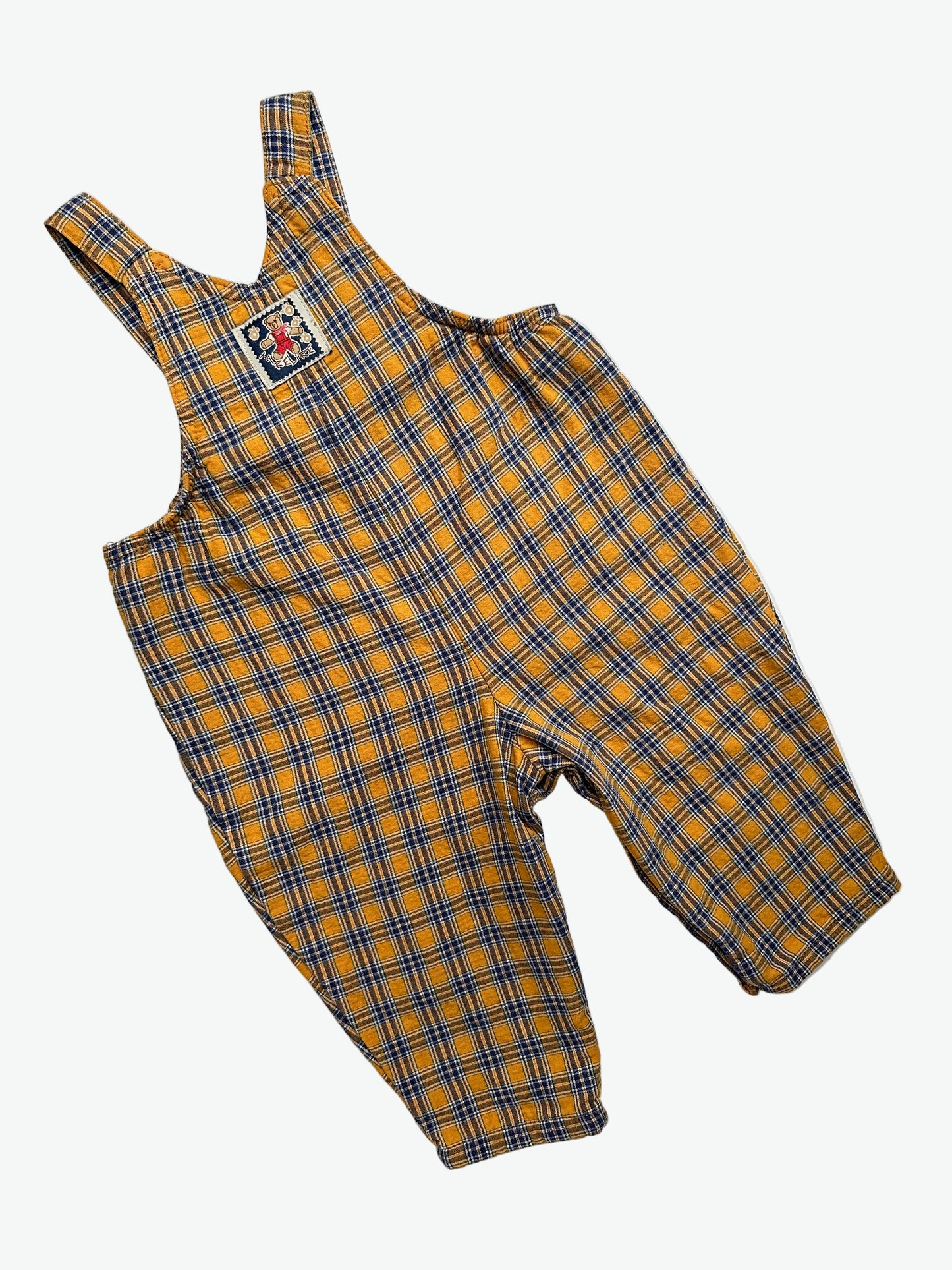 Yellow and blue Check dungarees with badge on a white background