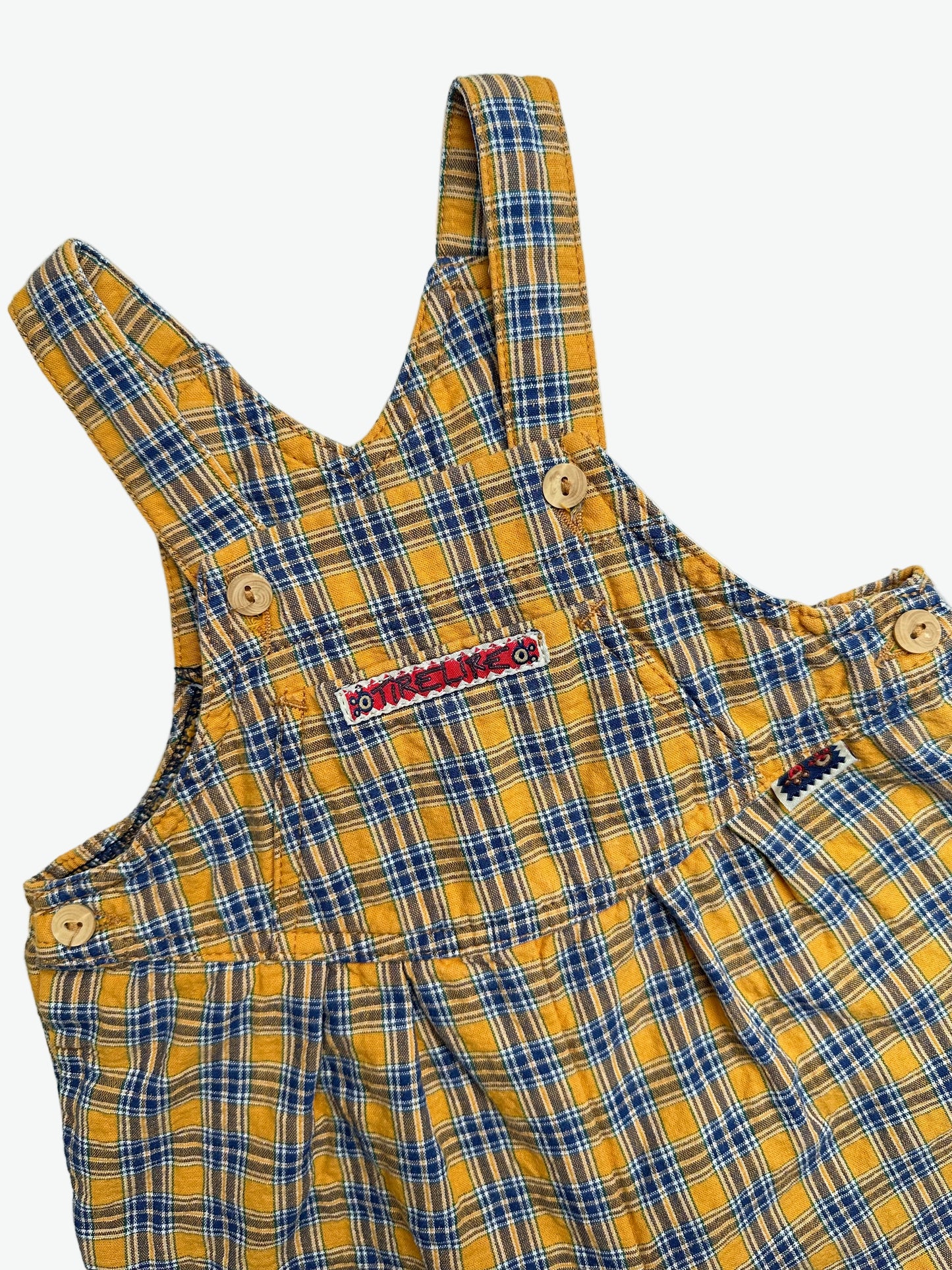 Yellow and blue Check dungarees with badge on a white background