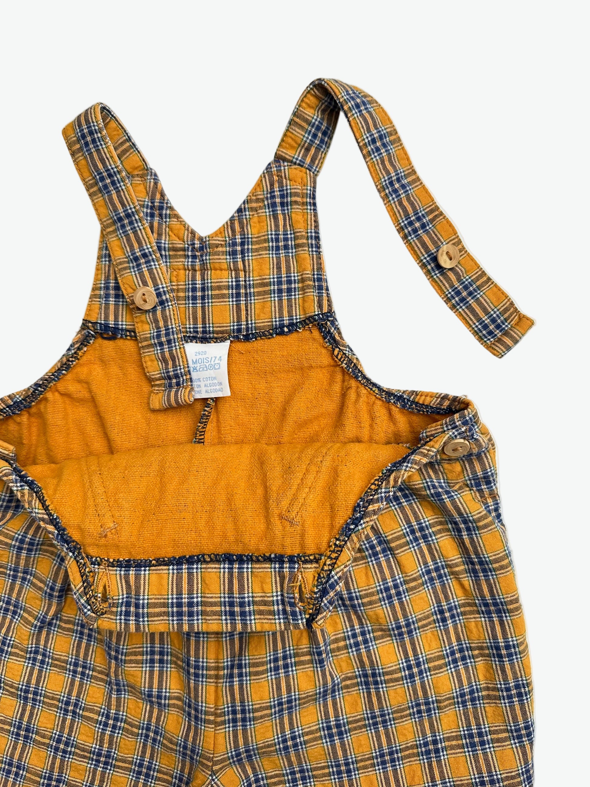 Yellow and blue check dungarees on a white background