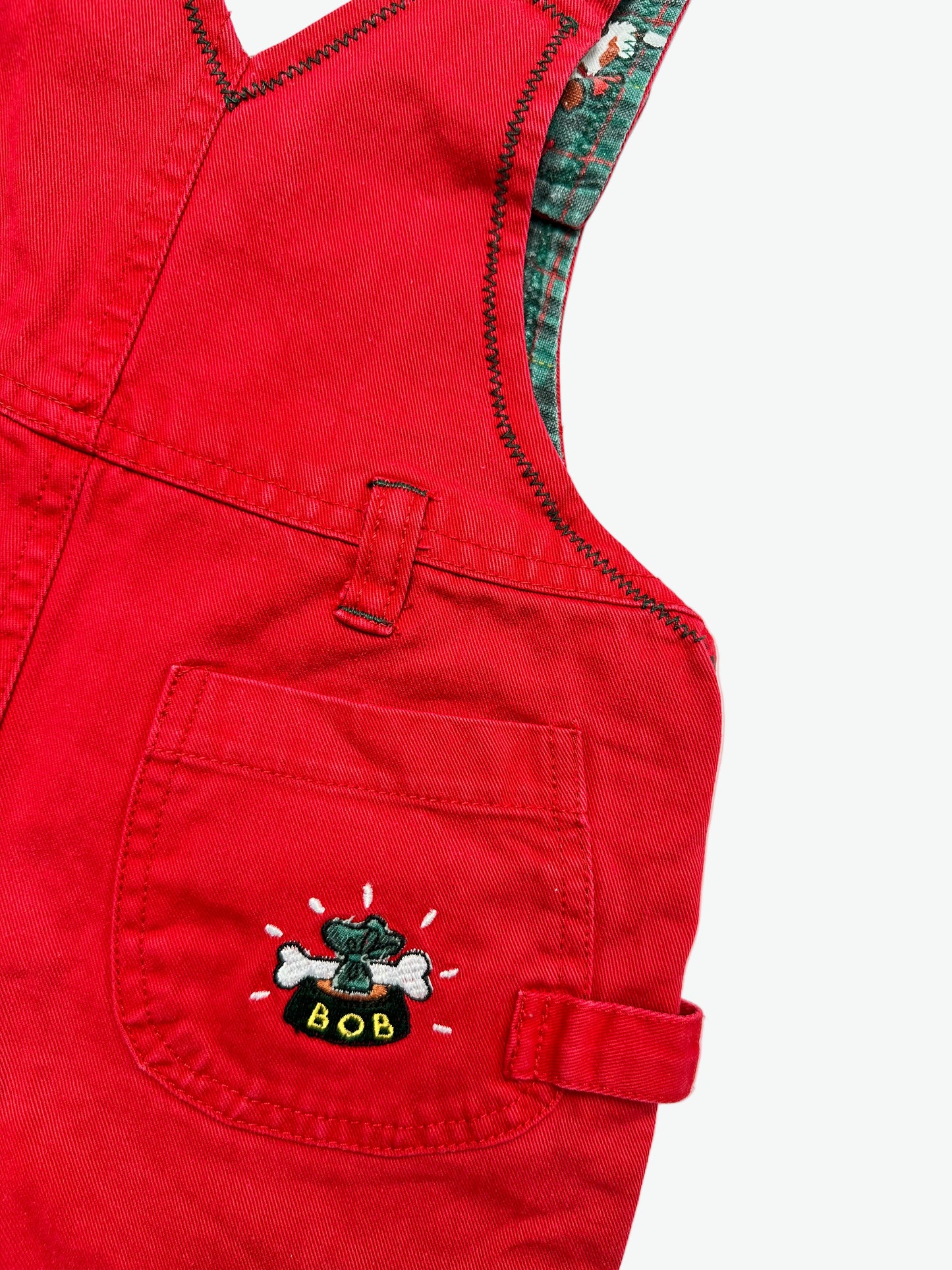 Kids vintage Red dungarees with a little dog embroidery on the pocket a white background