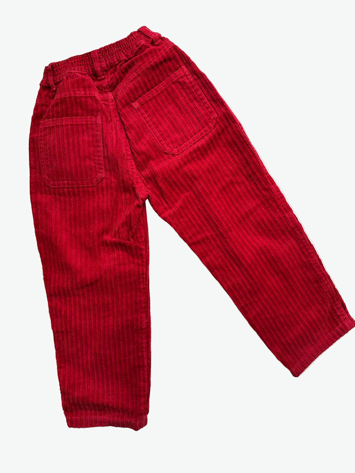 Red corduroy trousers on a white background