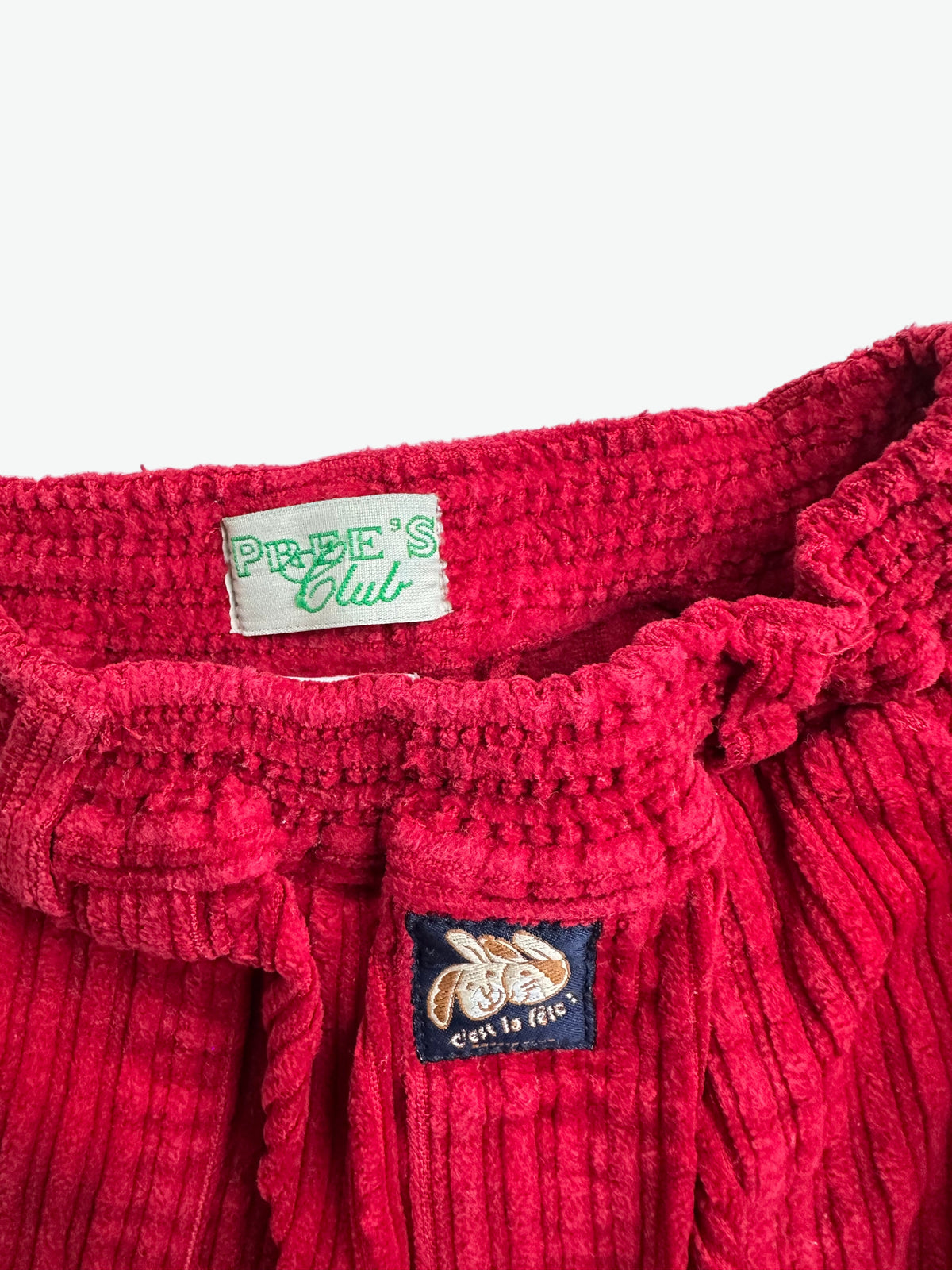 Red corduroy trousers on a white background