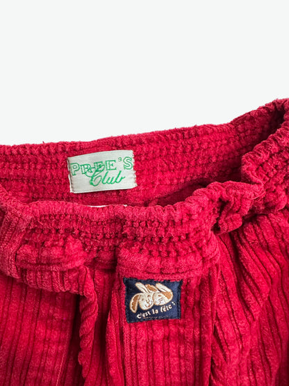 Red corduroy trousers on a white background