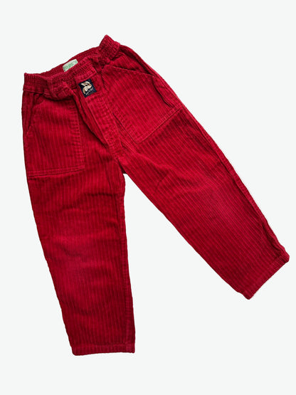Red corduroy trousers on a white background