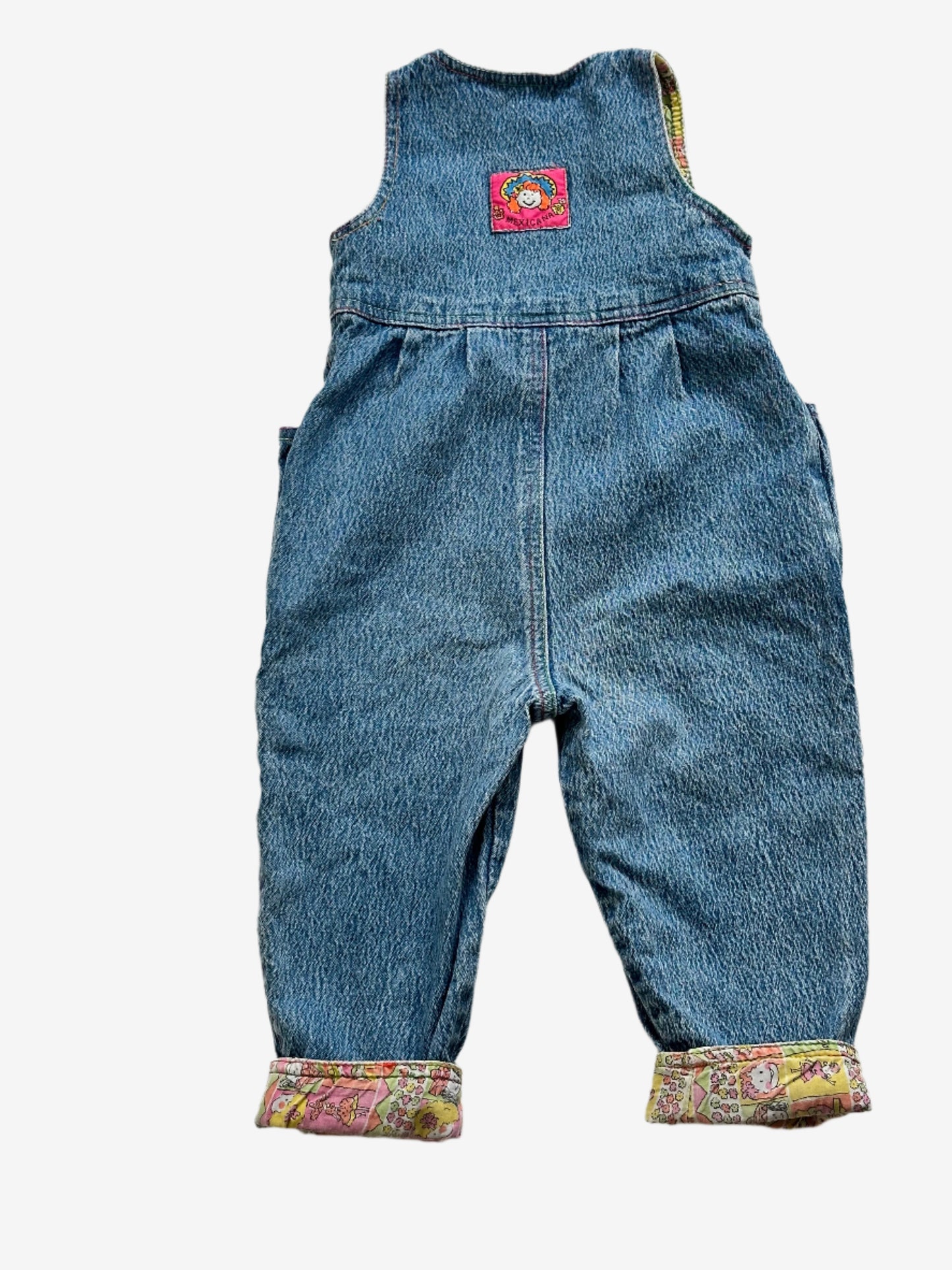 Kids vintage 90's Acid Wash Denim Romper  from British brand Adams, with rainbow stitching, pink buttons and a jazzy lining. Age 12 Months.