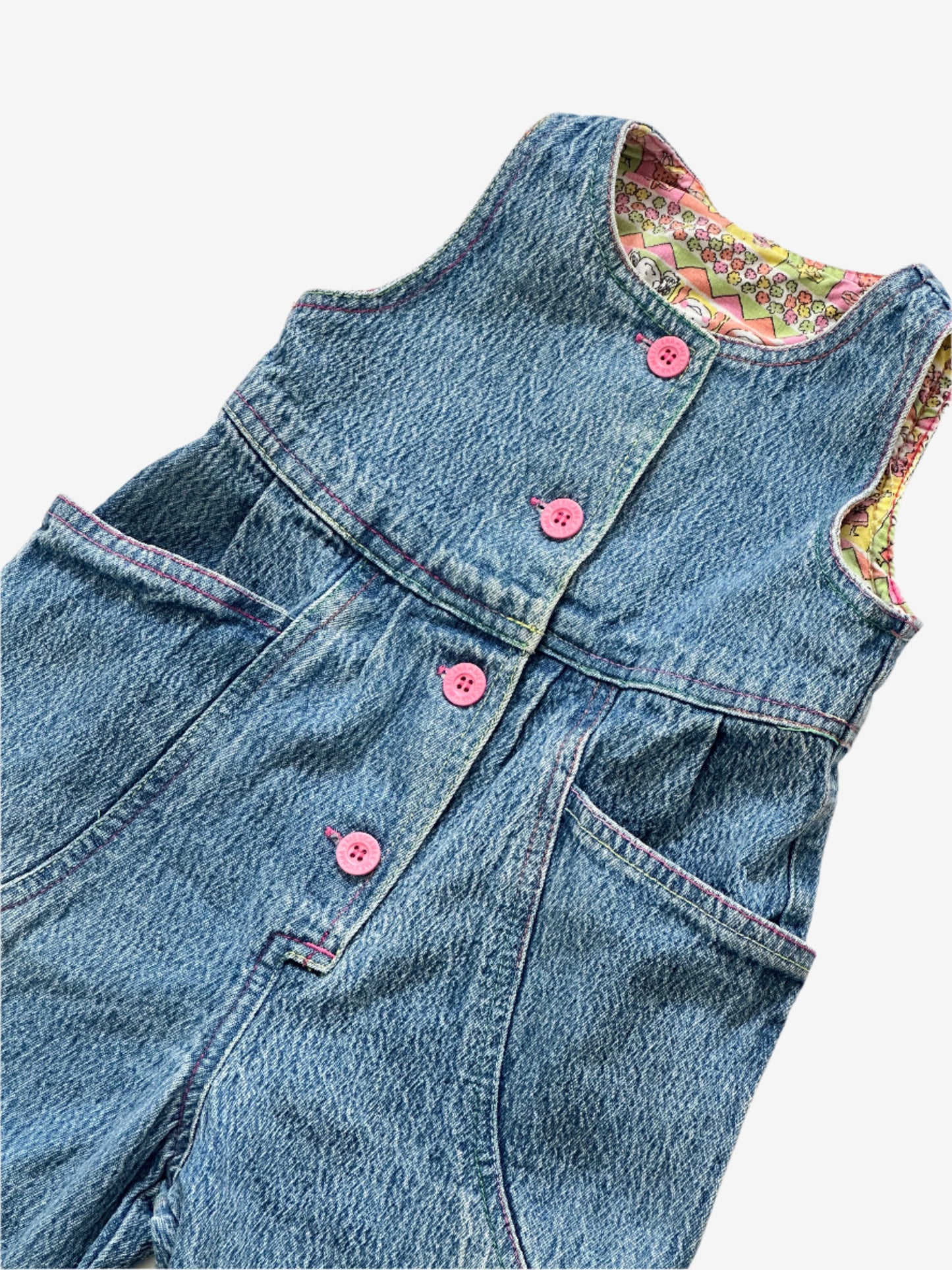 Kids vintage 90's Acid Wash Denim Romper  from British brand Adams, with rainbow stitching, pink buttons and a jazzy lining. Age 12 Months