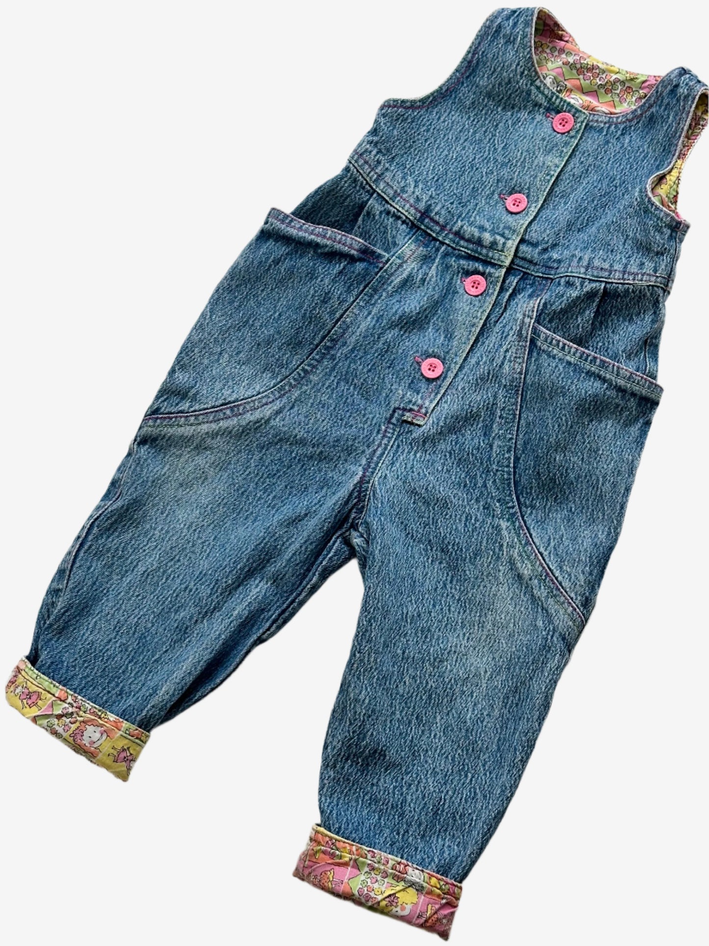 Kids vintage 90's Acid Wash Denim Romper  from British brand Adams, with rainbow stitching, pink buttons and a jazzy lining. Age 12 Months.