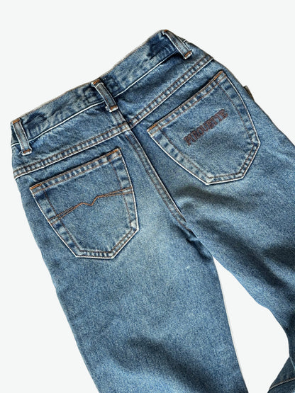 Pair of authentic blue jeans with silver hardware and back pocket embroidery on a white background