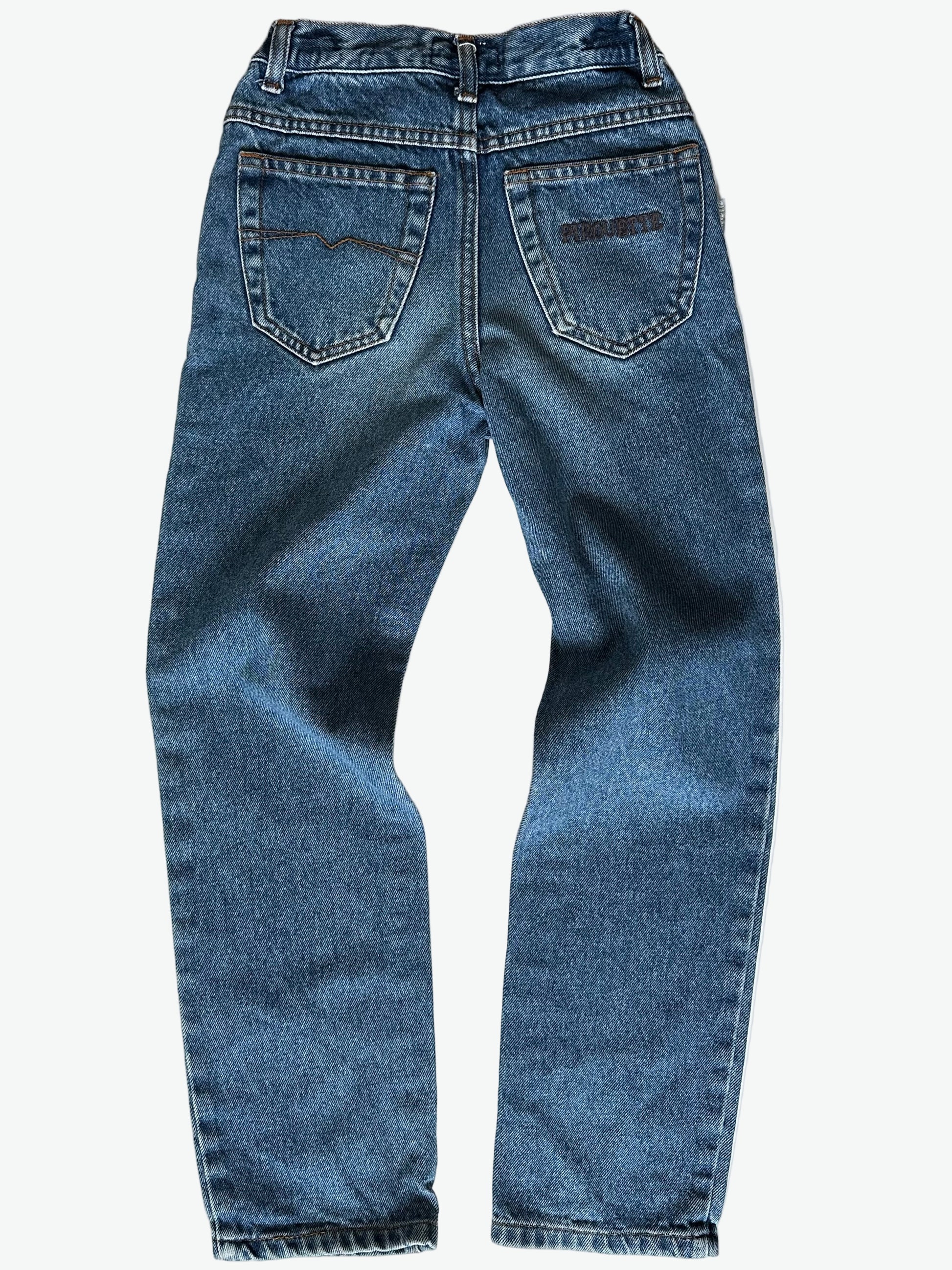 Pair of authentic blue jeans with back pocket embroidery and silver hardware on a white background
