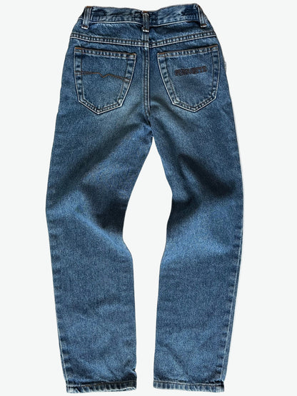 Pair of authentic blue jeans with back pocket embroidery and silver hardware on a white background