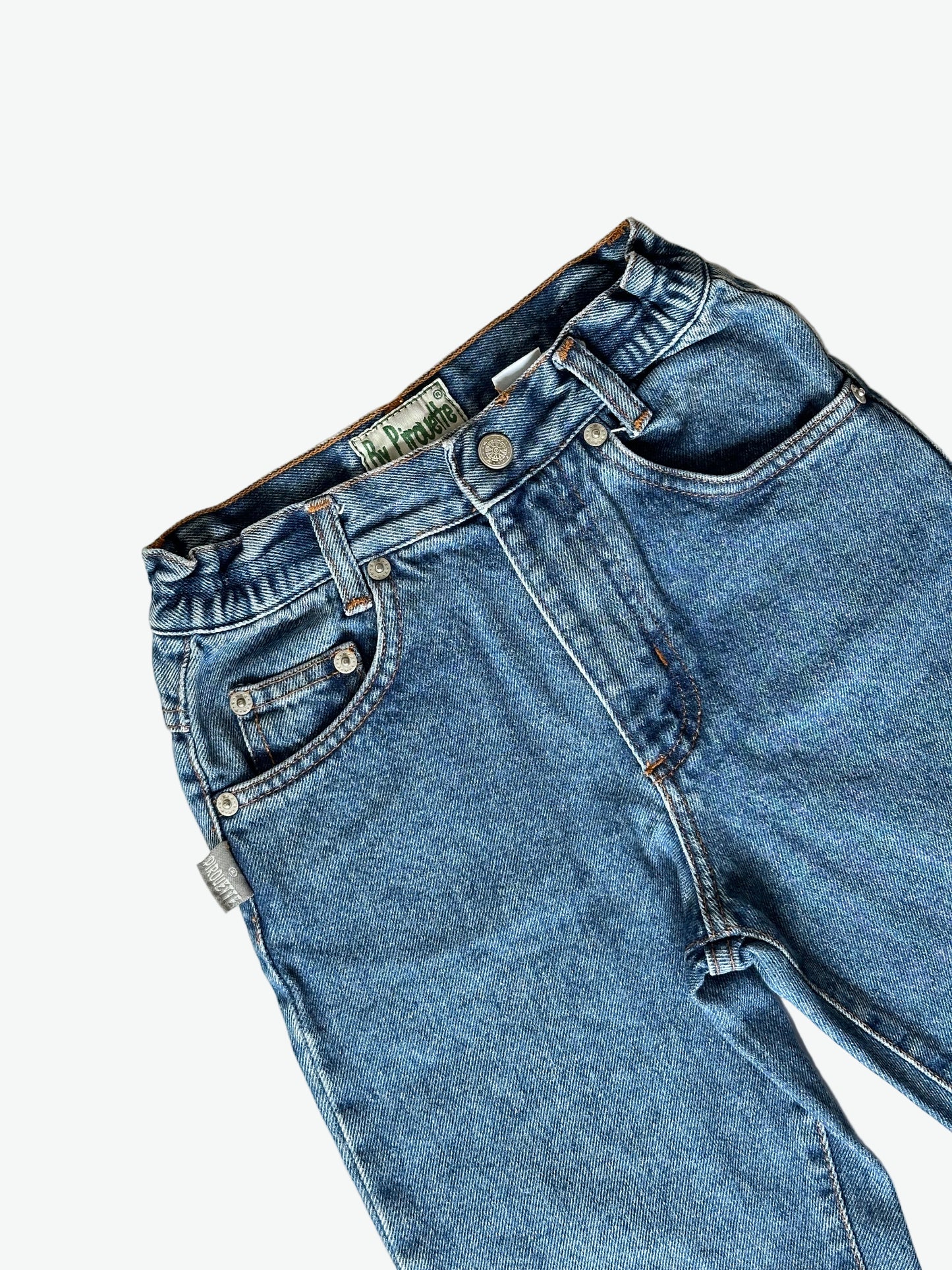 Pair of authentic blue jeans with silver hardware on a white background.