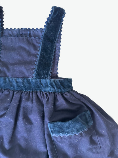 Navy blue dress with scallop trim edging on a white background