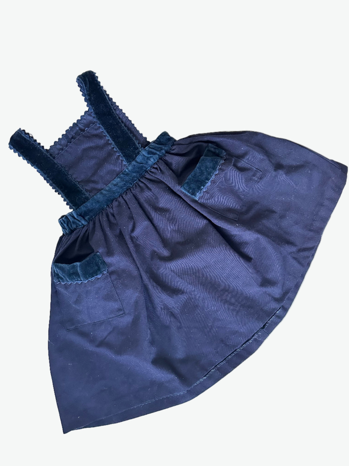 Navy blue dress with scallop trim edging on a white background