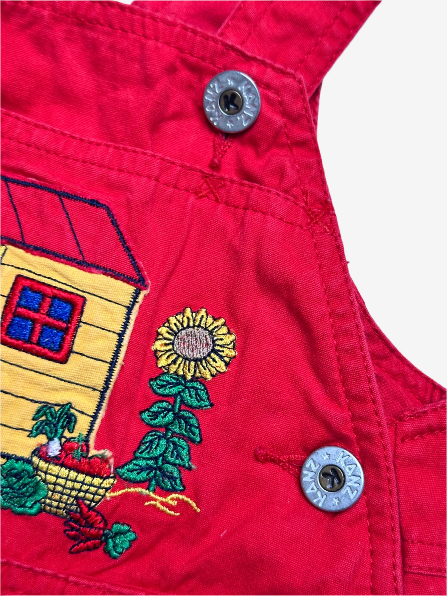 Kids vintage bold red with a relaxed bubble fit, featuring beautifully detailed embroidery or a bear tending the garden. Age 1 years.