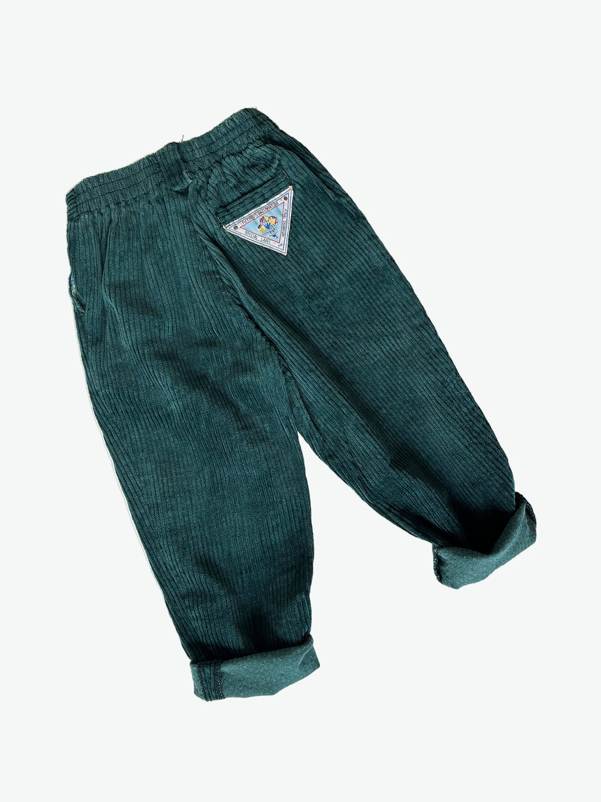 Dark Green corduroy pants with a triangle patch on a white background