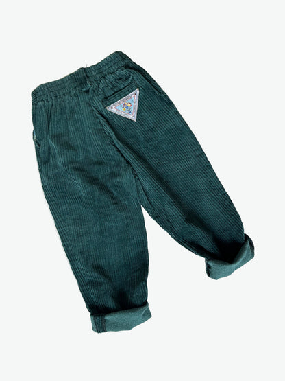 Dark Green corduroy pants with a triangle patch on a white background
