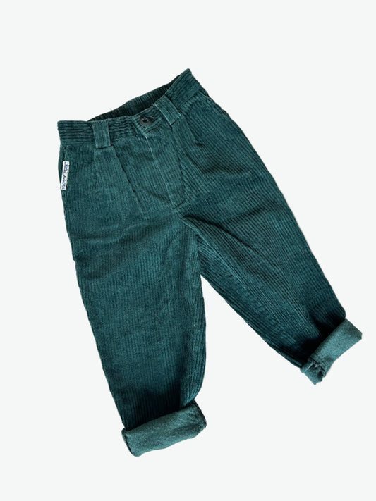Dark green corduroy pants on a white background