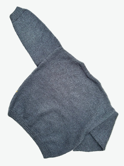 Kids vintage hand knitted jumper with a Goofy and checkerboard design on the front on a white background