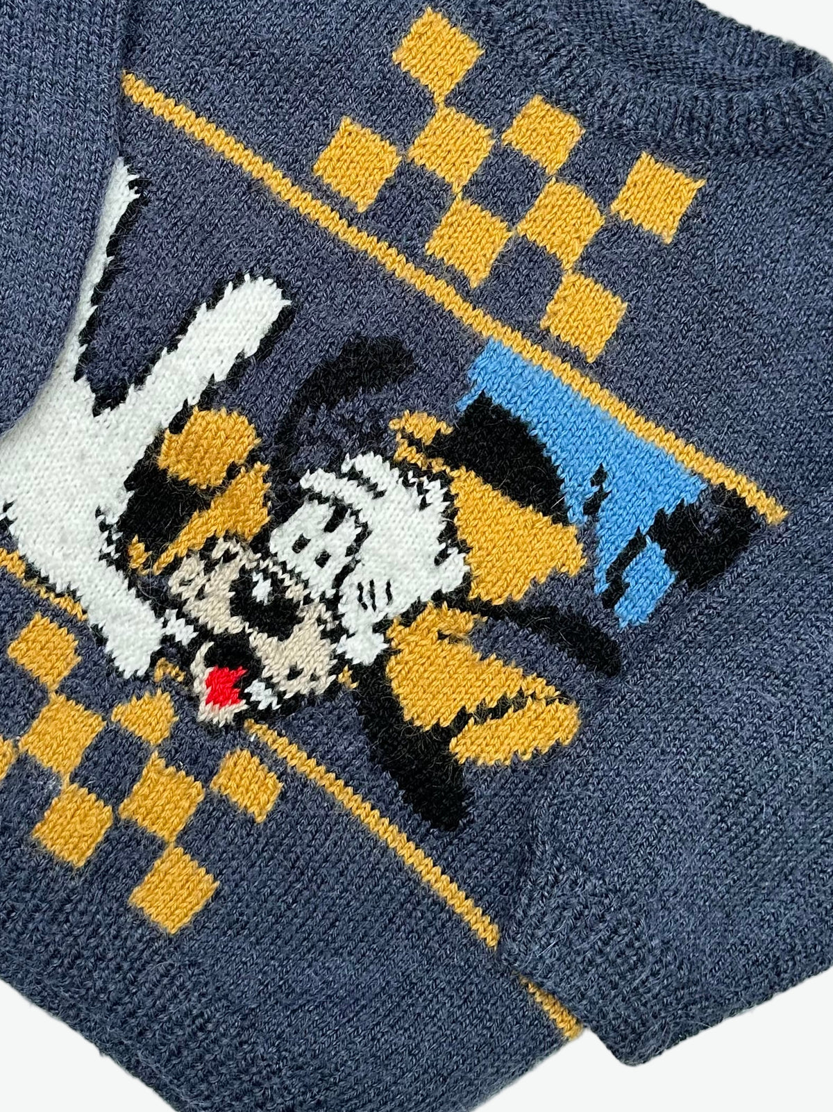Kids vintage hand knitted jumper with a Goofy and checkerboard design on the front on a white background
