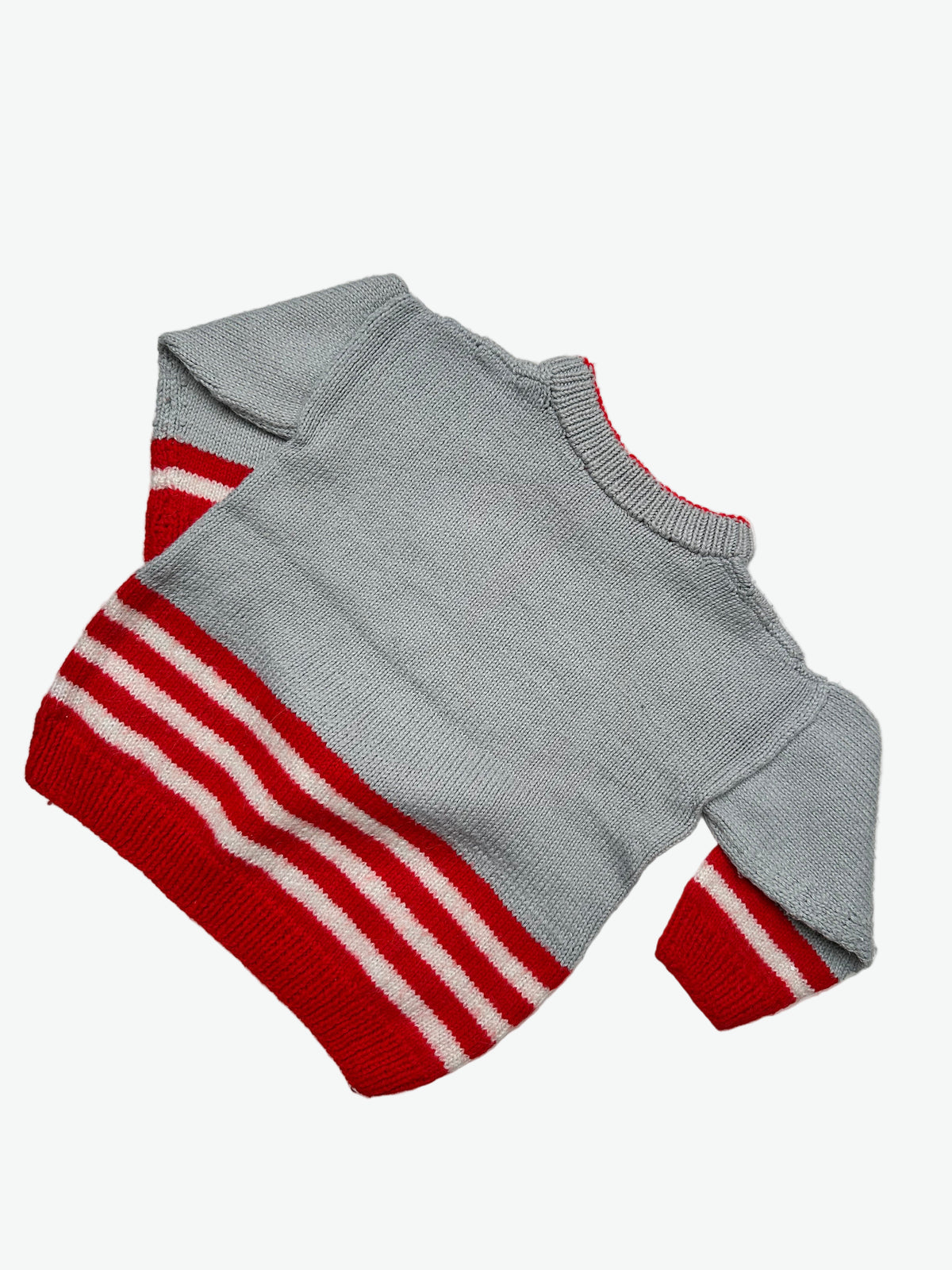Grey Hand knitted 101 Dolmatians jumper with red and white pattern on a light gray background