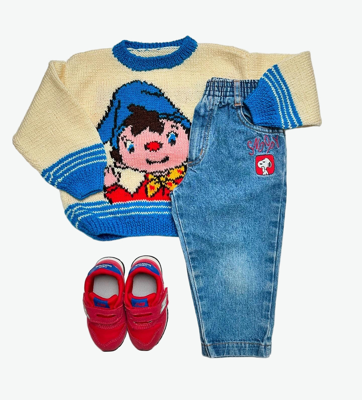 Kids vintage cream knitted jumper with the character knoddy and blue stripes at the hem and cuffs on a white background