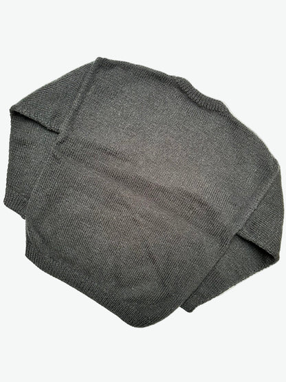 Knitted Black jumper with a colourful graphic of the character Spirou on a light gray background
