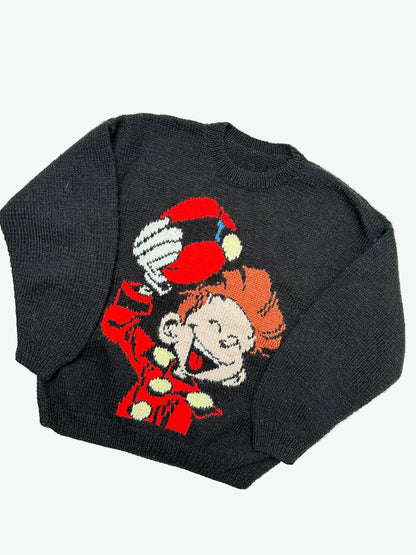 Knitted Black jumper with a colourful graphic of the character Spirou on a light gray background