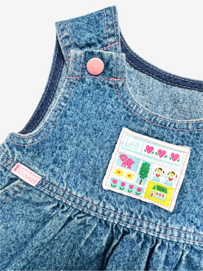 Kids Vintage acid wash dress from denim brand Lee, made in U.S.A, features an adorable chest badge featuring hearts, flowers, a tiny house, and a dog to the sweet pink enamelled popper fastenings on the straps. The A-line shape with gentle gathering at the waist makes it comfy and easy to wear. Age 2 years.