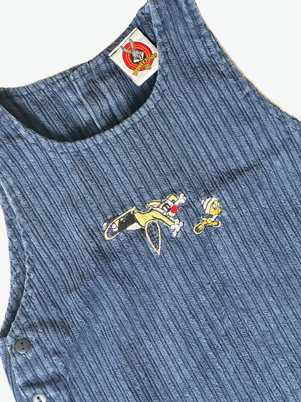Blue corduroy shift dress with embroidered design on a white background